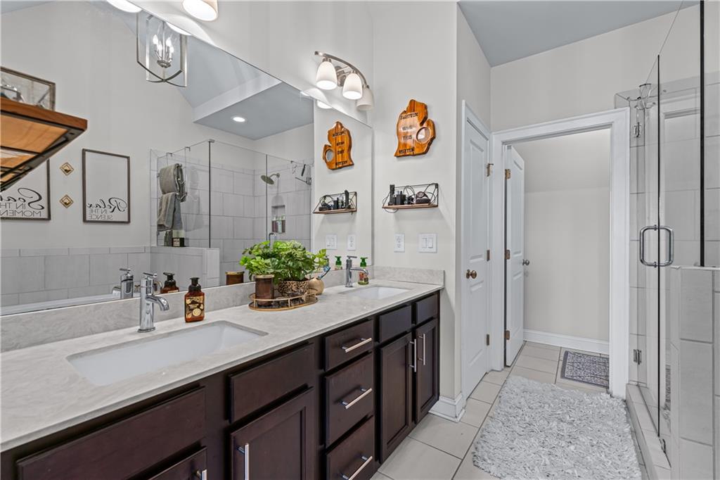 3766 Alstead Manor Way Suwanee, GA 30024 - Photo 27 of 41 a bathroom with a sink and a mirror