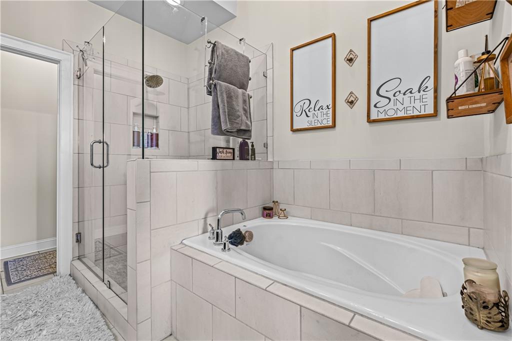 3766 Alstead Manor Way Suwanee, GA 30024 - Photo 28 of 41 a bathroom with a bathtub and a shower