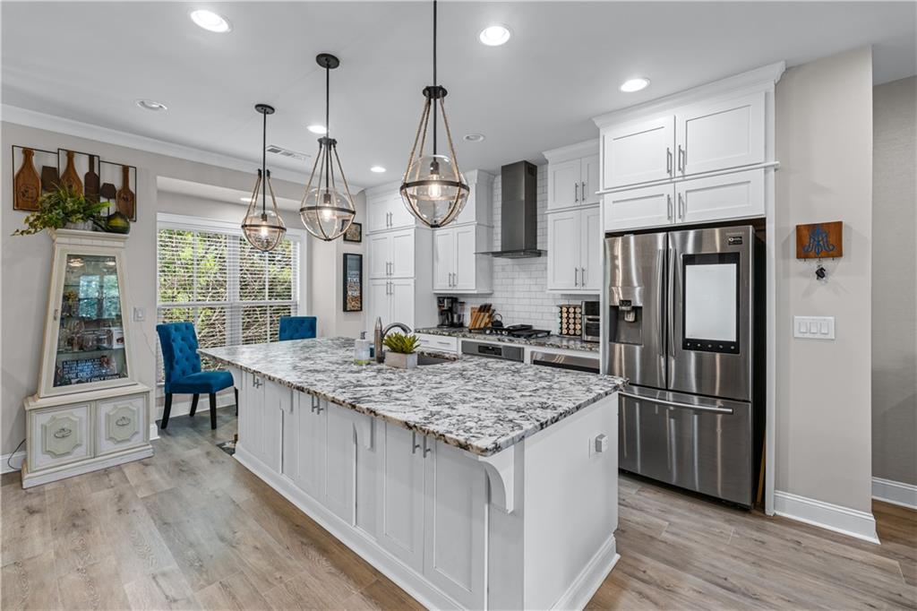 3766 Alstead Manor Way Suwanee, GA 30024 - Photo 7 of 41 a kitchen with stainless steel appliances granite countertop a refrigerator a sink and a stove