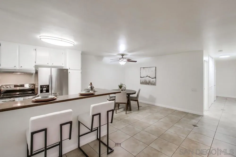 3583 Ruffin Road, Unit 112 San Diego, CA 92123 - Photo 8 of 59 a kitchen with stainless steel appliances granite countertop a sink a stove a dining table and chairs