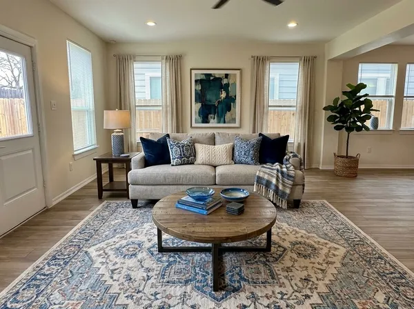a living room with furniture and a potted plant