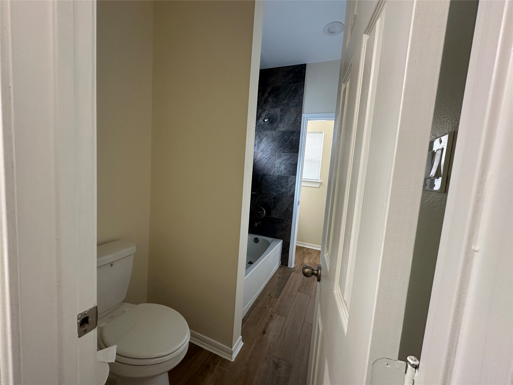 2015 Harlem Street Houston, TX 77020 - Photo 16 of 18 a bathroom with a granite countertop toilet and a sink