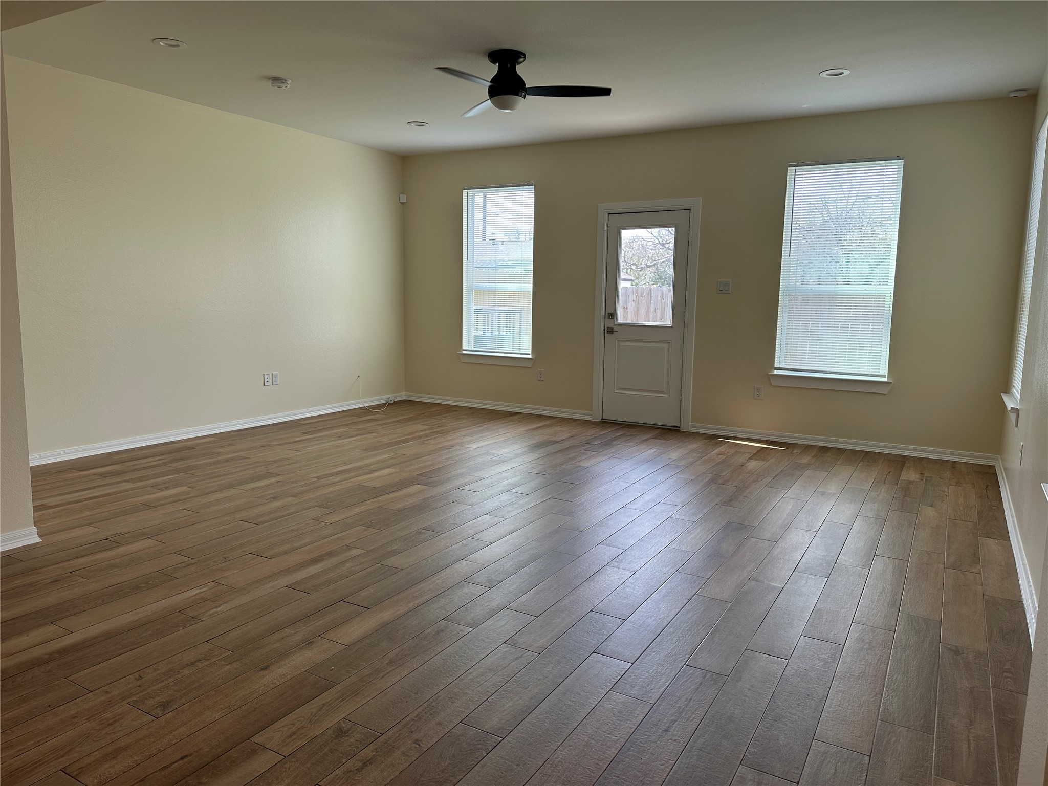 2015 Harlem Street Houston, TX 77020 - Photo 3 of 18 a view of an empty room with wooden floor and a window