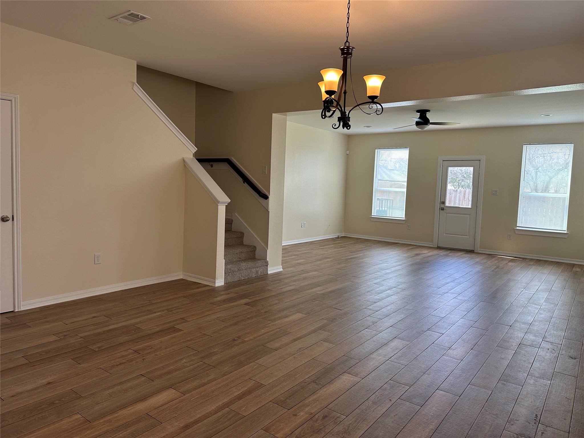 2015 Harlem Street Houston, TX 77020 - Photo 4 of 18 a view of a room with wooden floor ceiling fan and windows