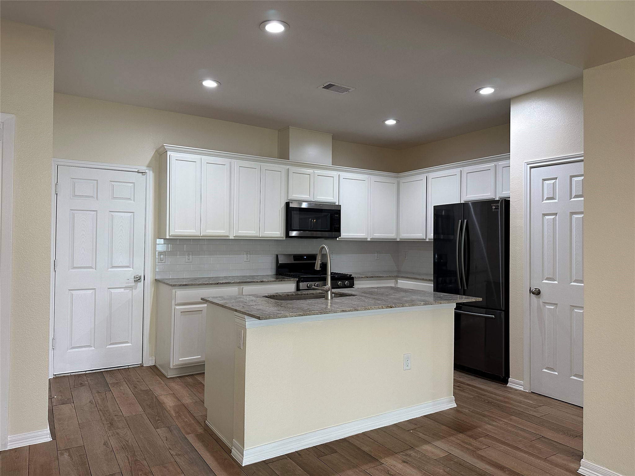 2015 Harlem Street Houston, TX 77020 - Photo 8 of 18 a kitchen with stainless steel appliances granite countertop a refrigerator and a stove top oven