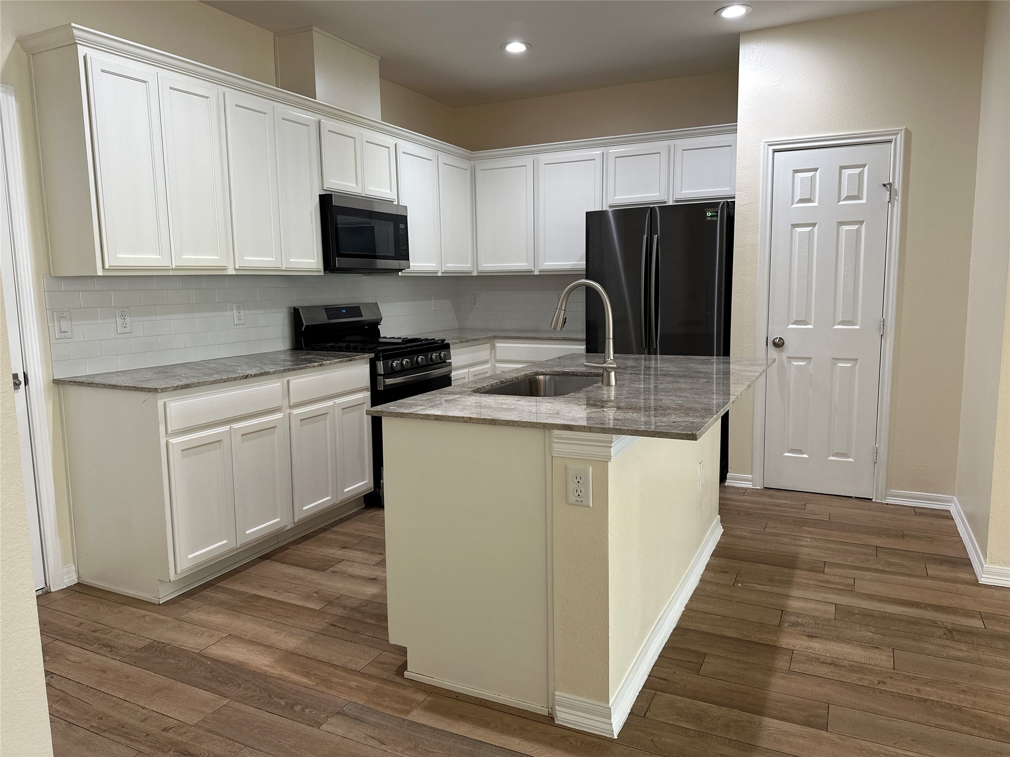 2015 Harlem Street Houston, TX 77020 - Photo 9 of 18 a kitchen with stainless steel appliances granite countertop a refrigerator stove microwave and sink