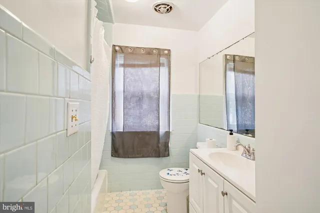 a living room with furniture and a dresser