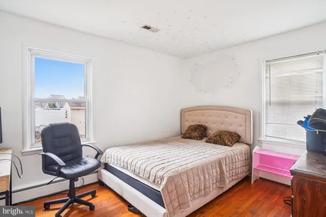 a bedroom with a bed and a tv