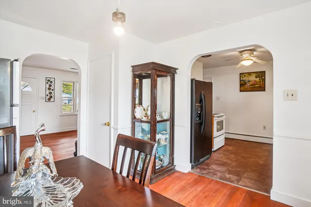 a view of a hallway with wooden floor and windows