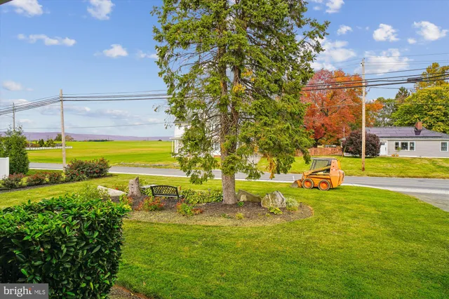 a view of a swimming pool with an outdoor seating and a yard