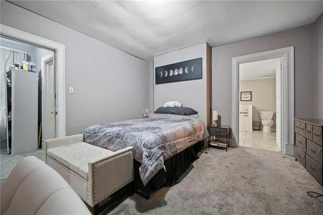 a bedroom with a bed and a view of bathroom