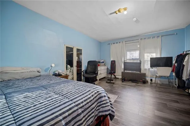 a bedroom with a bed and a chair