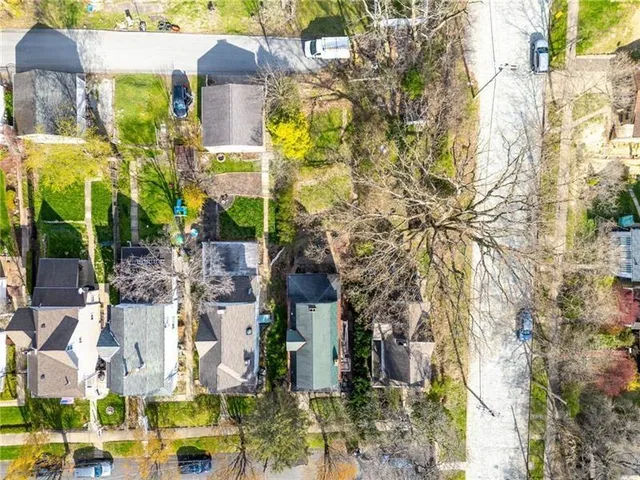 a multi story building with trees in front of it