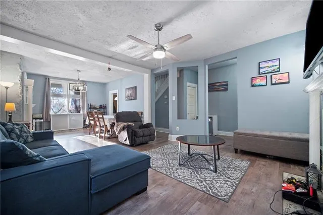 a living room with furniture and a dining table