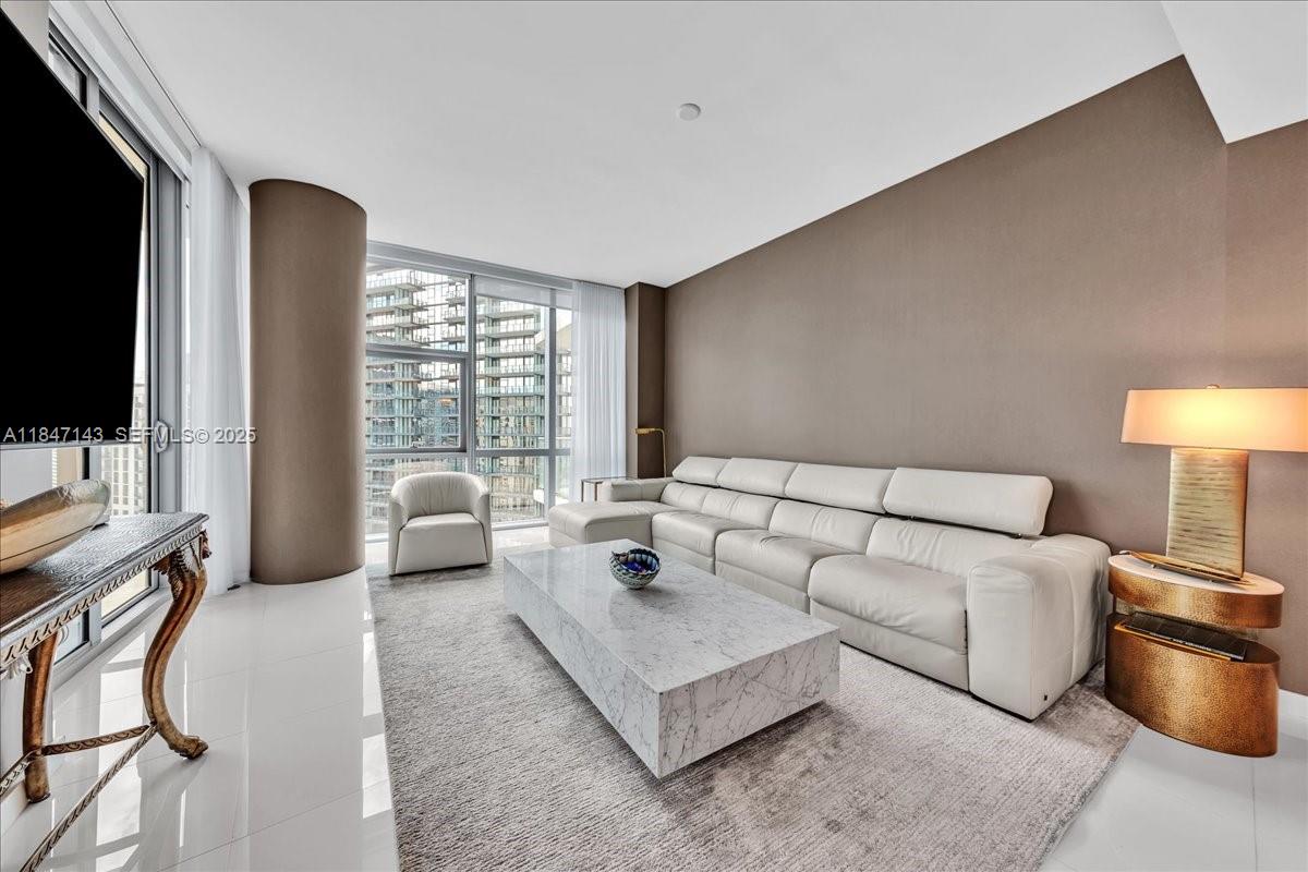 851 Northeast 1st Avenue, Unit 3711 Miami, FL 33132 - Photo 11 of 47 a living room with furniture and a flat screen tv