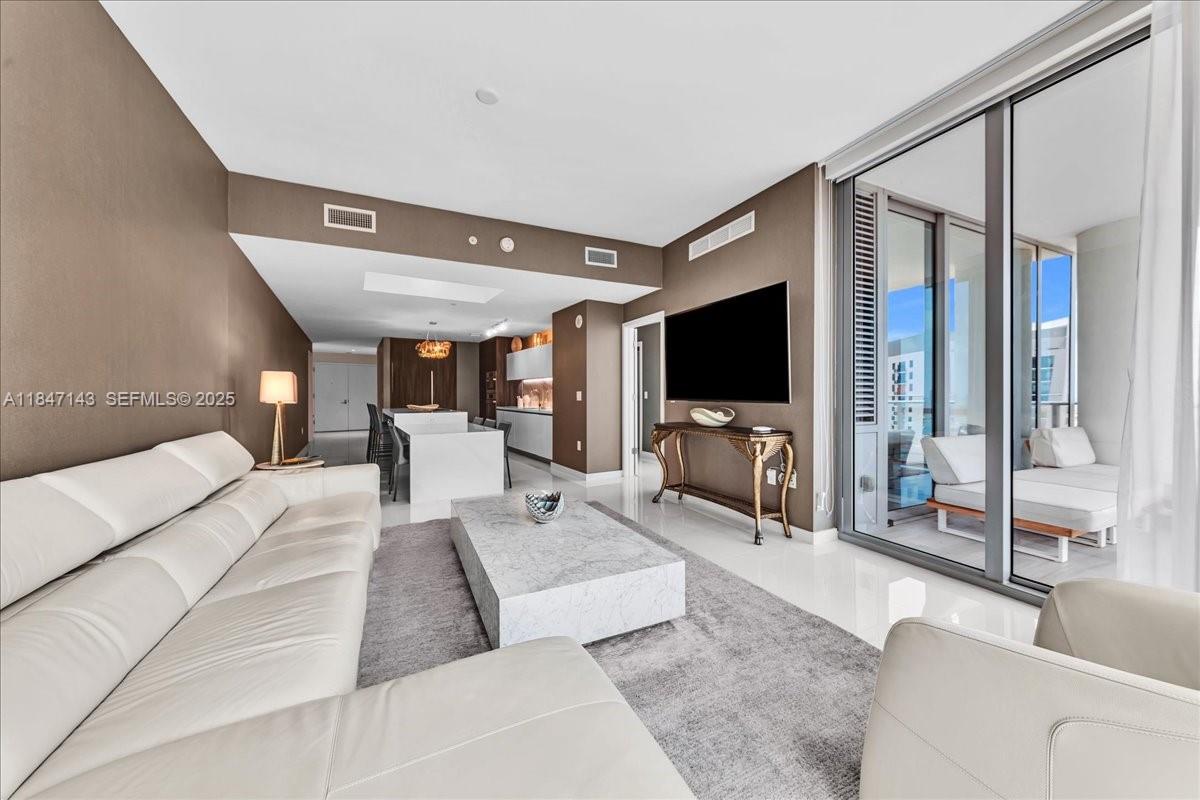 851 Northeast 1st Avenue, Unit 3711 Miami, FL 33132 - Photo 12 of 47 a living room with furniture and a flat screen tv