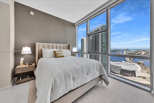 a bed room with a bed and a night stand