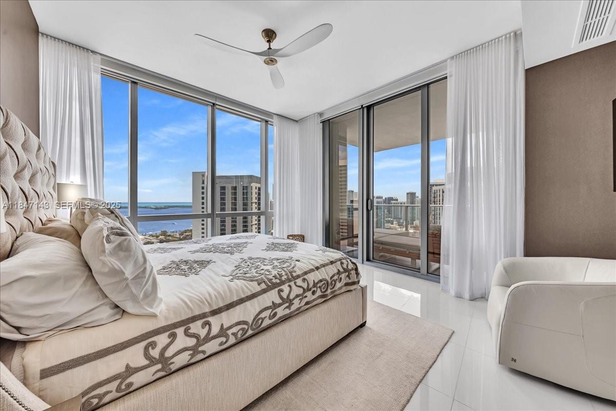 851 Northeast 1st Avenue, Unit 3711 Miami, FL 33132 - Photo 19 of 47 a spacious bedroom with a large bed and a large window
