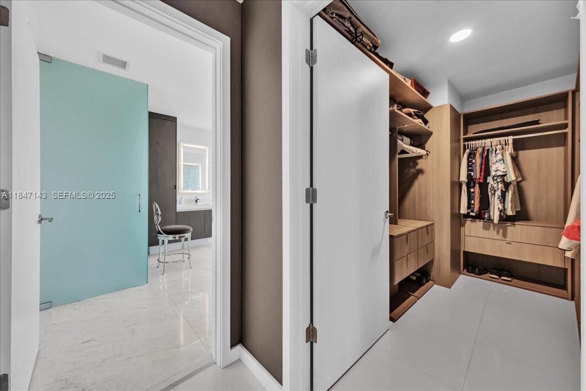851 Northeast 1st Avenue, Unit 3711 Miami, FL 33132 - Photo 21 of 47 a view of walk in closet and bedroom