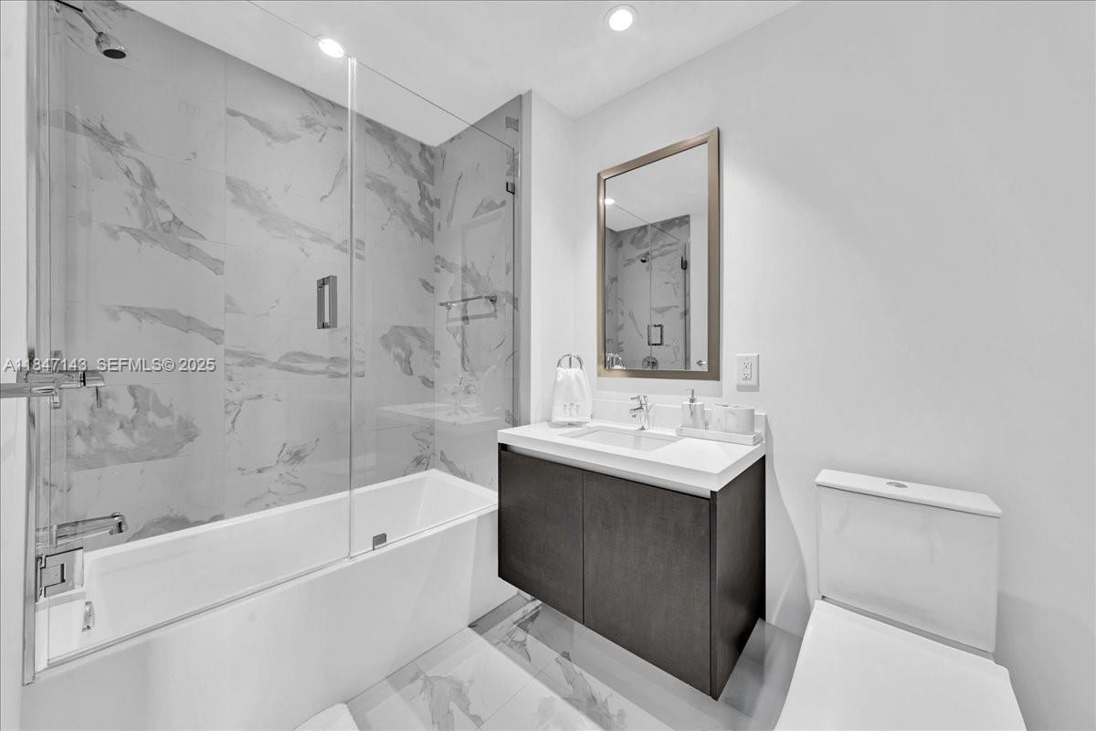 851 Northeast 1st Avenue, Unit 3711 Miami, FL 33132 - Photo 30 of 47 a bathroom with a sink a toilet and shower