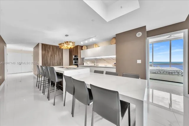 a large kitchen with a table and chairs