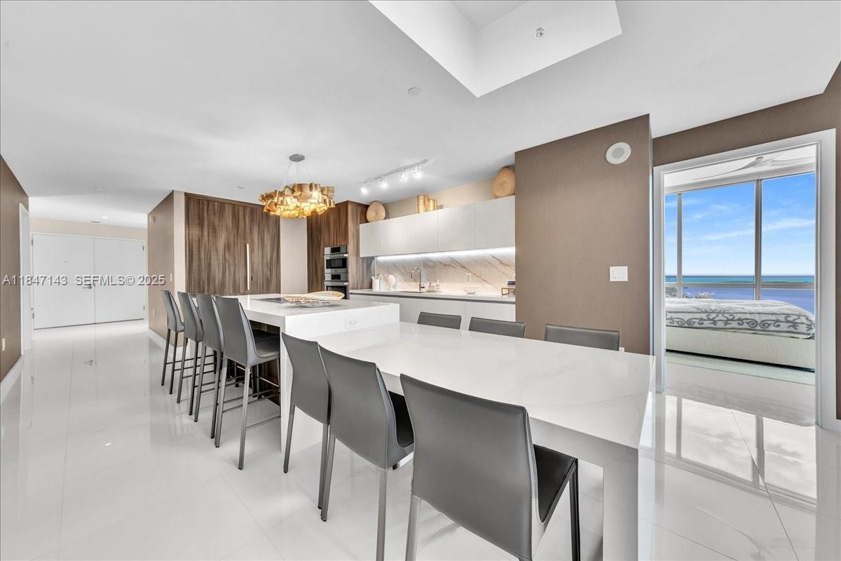 851 Northeast 1st Avenue, Unit 3711 Miami, FL 33132 - Photo 3 of 47 a large kitchen with a table and chairs