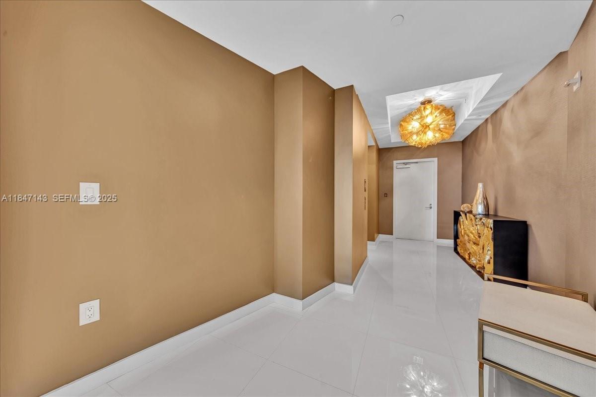 851 Northeast 1st Avenue, Unit 3711 Miami, FL 33132 - Photo 35 of 47 a bedroom with a bed and a flat tv screen on dresser