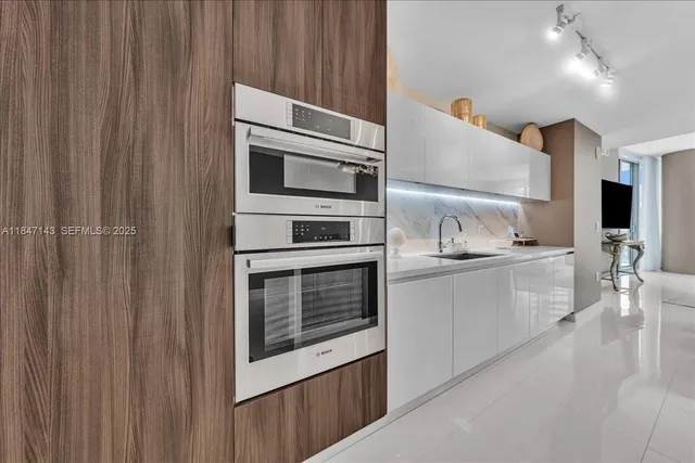 a kitchen with stainless steel appliances a refrigerator and microwave