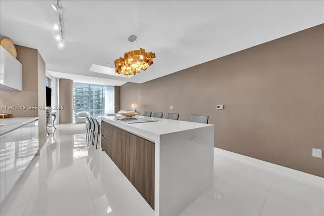 a large white kitchen with a large window