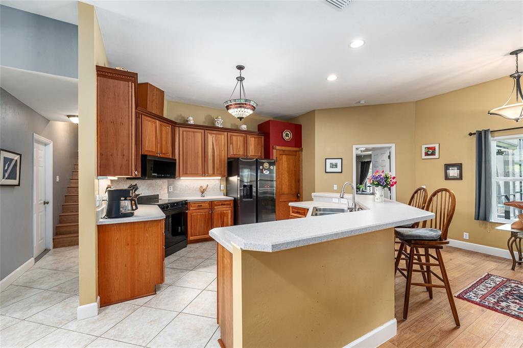 8420 Southwest 92nd Lane Gainesville, FL 32608 - Photo 11 of 46 a kitchen with a stove a refrigerator and a dining table