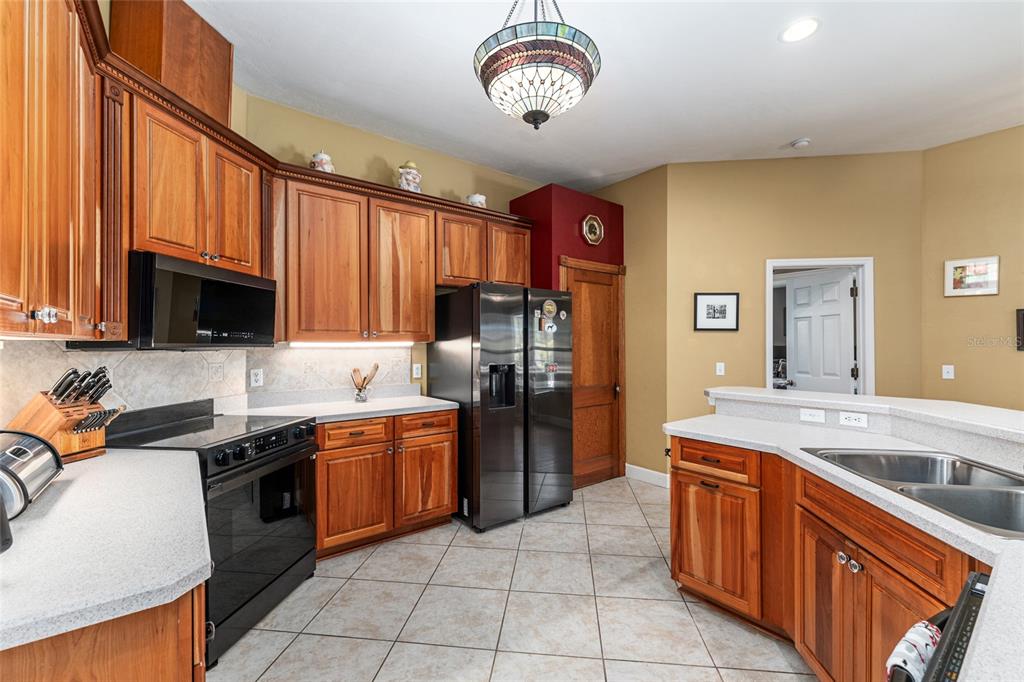 8420 Southwest 92nd Lane Gainesville, FL 32608 - Photo 12 of 46 a kitchen with stainless steel appliances granite countertop a sink a stove top oven a counter space and cabinets