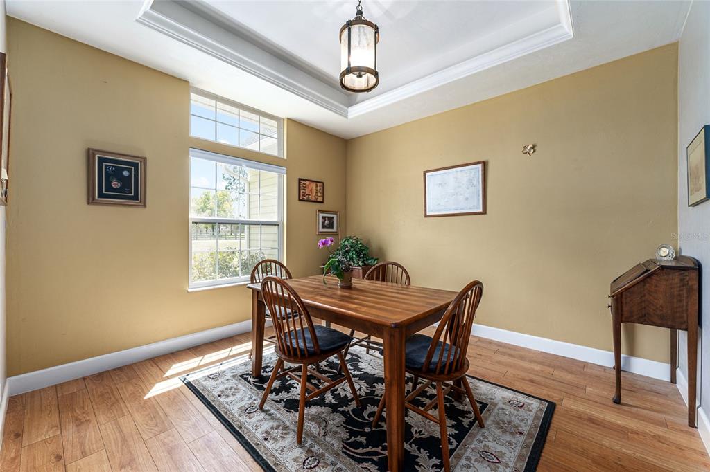 8420 Southwest 92nd Lane Gainesville, FL 32608 - Photo 15 of 46 a view of a dining room with furniture window and wooden floor