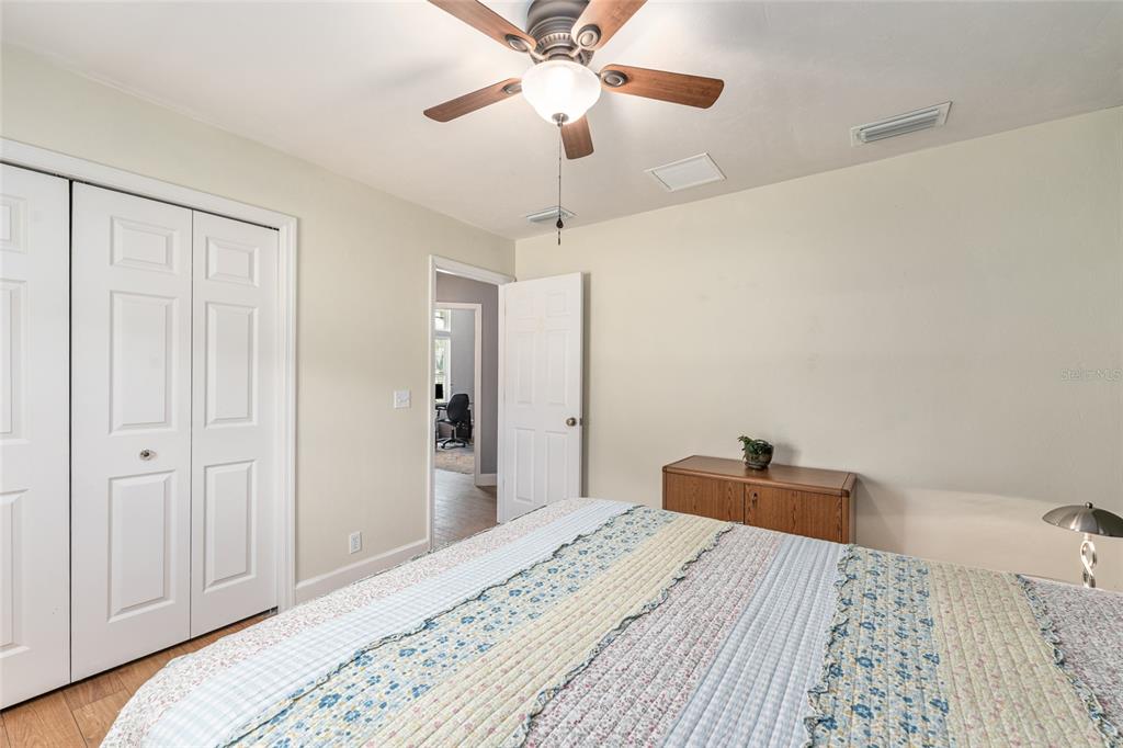 8420 Southwest 92nd Lane Gainesville, FL 32608 - Photo 20 of 46 a bedroom with a bed and a chandelier