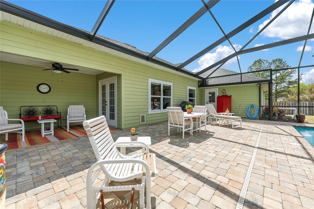 8420 Southwest 92nd Lane Gainesville, FL 32608 - Photo 34 of 46 a view of a patio with a dining table and chairs with wooden floor