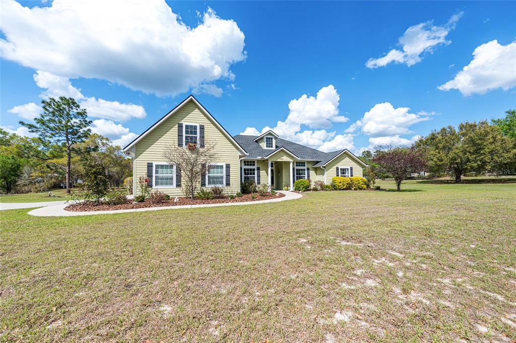 8420 Southwest 92nd Lane Gainesville, FL 32608 - Photo 4 of 46 a view of a house with a yard and chandelier