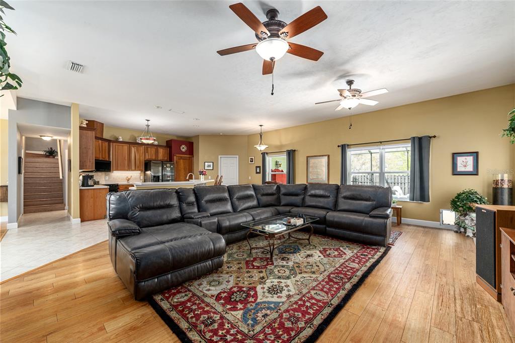 8420 Southwest 92nd Lane Gainesville, FL 32608 - Photo 10 of 46 a living room with furniture kitchen view and a chandelier