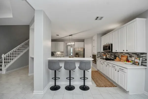 a kitchen with stainless steel appliances a sink and cabinets