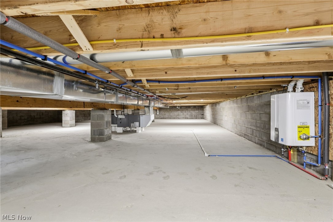 6535 North Ridge Road West Geneva, OH 44041 - Photo 35 of 48 Unfinished below grade area featuring tankless water heater