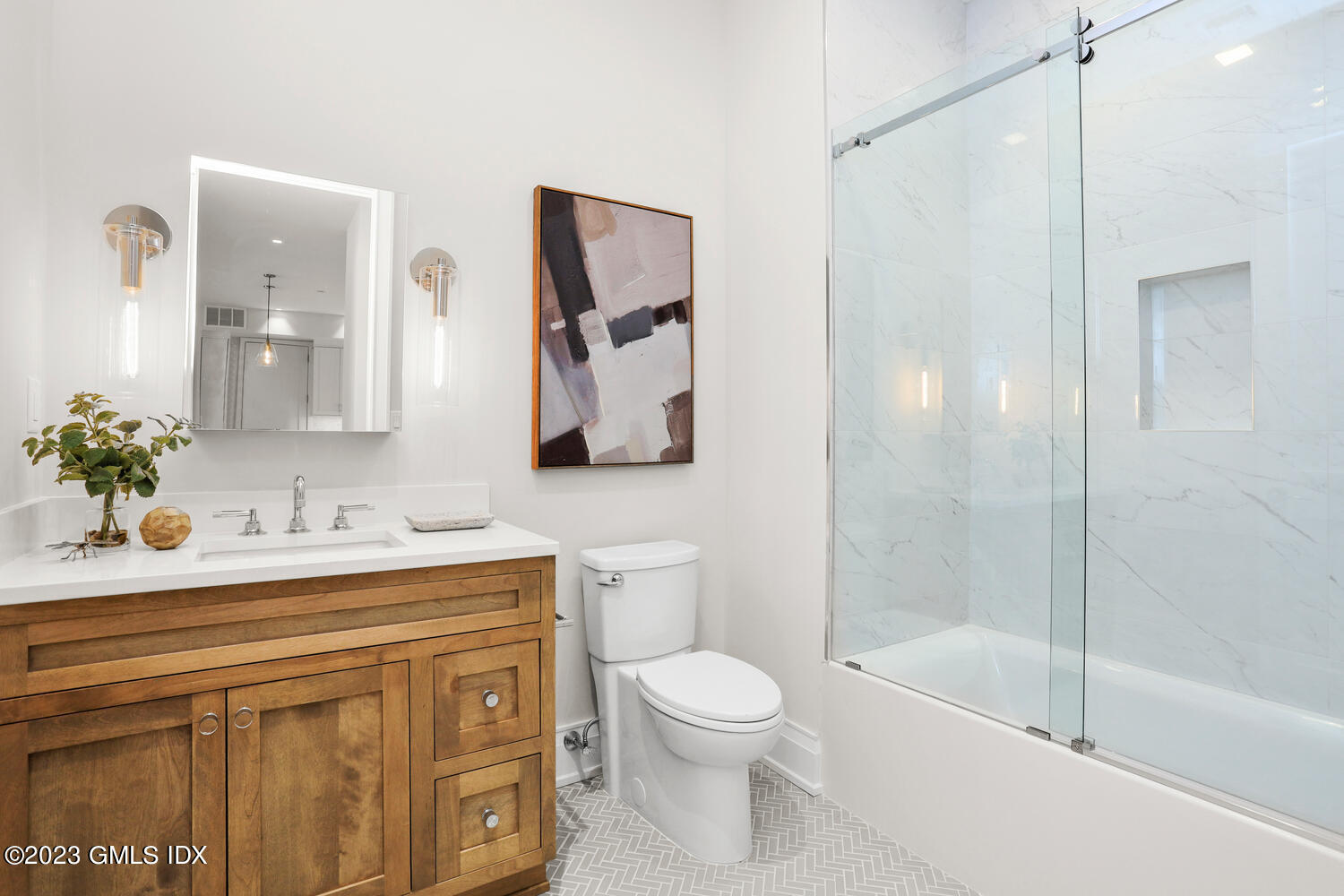 88 South Water Street, Unit 106 Greenwich, CT 06830 - Photo 12 of 24 a bathroom with a granite countertop sink a toilet and shower