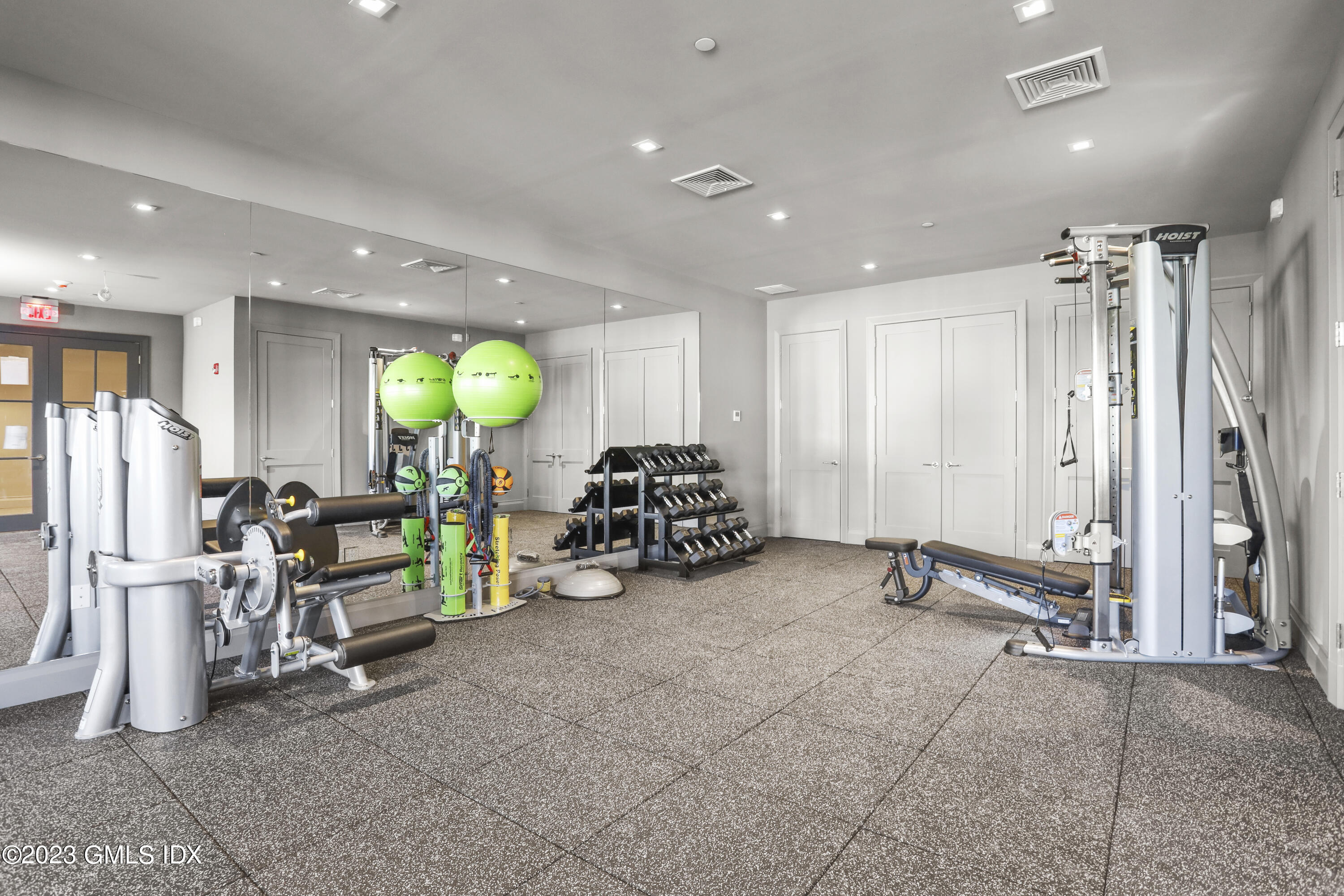 88 South Water Street, Unit 106 Greenwich, CT 06830 - Photo 19 of 24 a view of a room with gym equipment and a large mirror