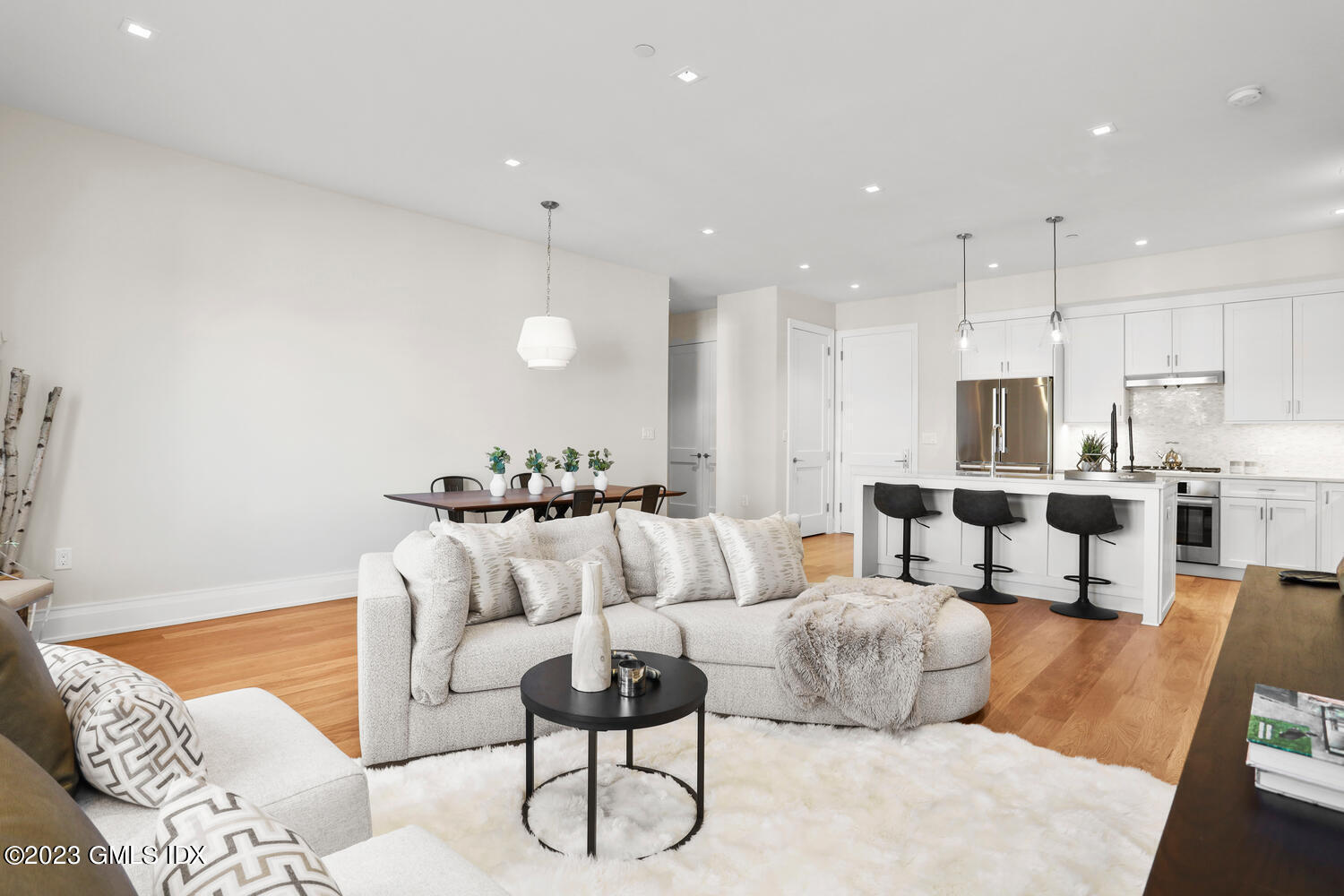 88 South Water Street, Unit 106 Greenwich, CT 06830 - Photo 4 of 24 a living room with furniture kitchen and a chandelier