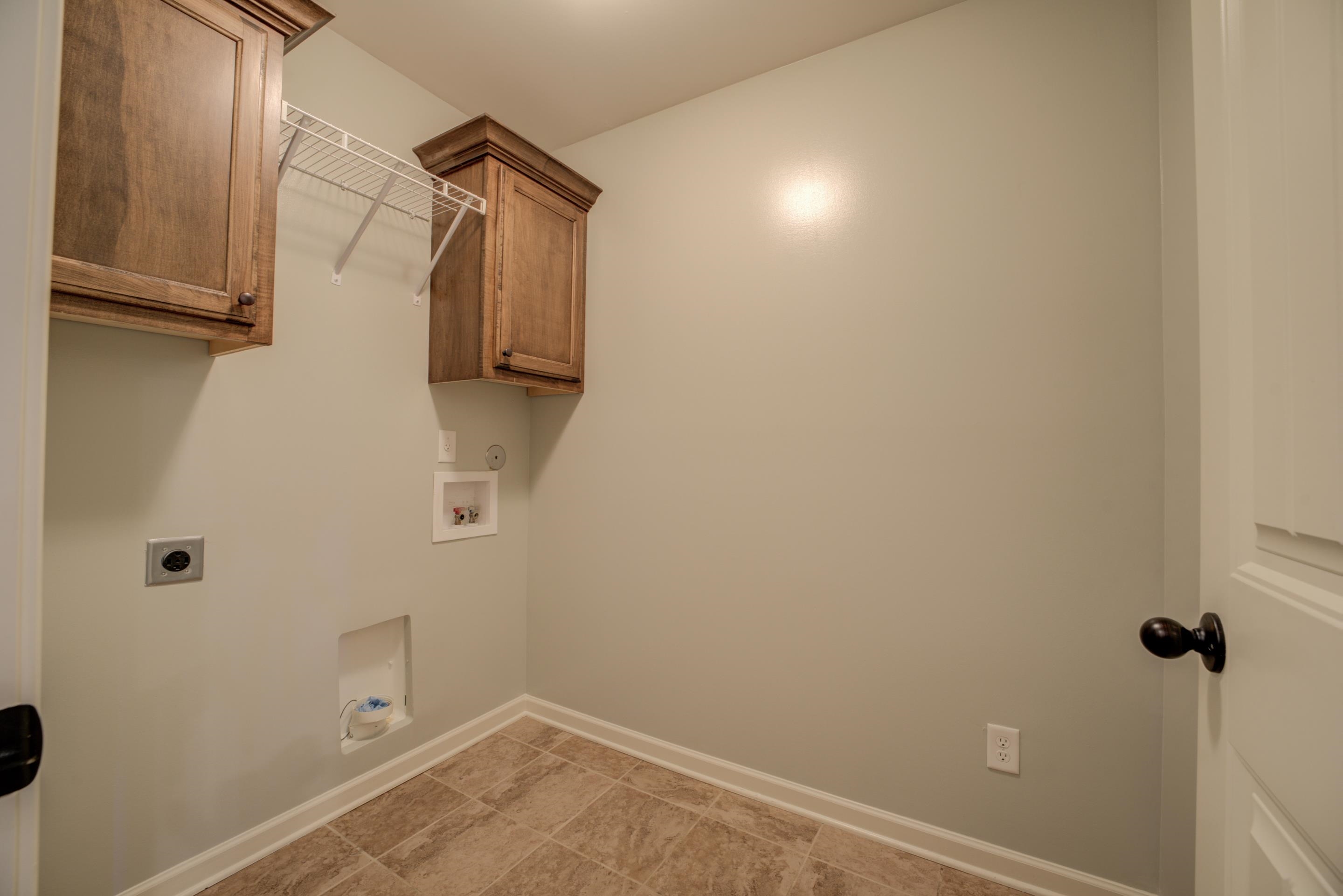 370 Pearl Road Somerville, TN 38068 - Photo 23 of 39 Clothes washing area with light tile patterned flooring, hookup for a washing machine, hookup for an electric dryer, and cabinets