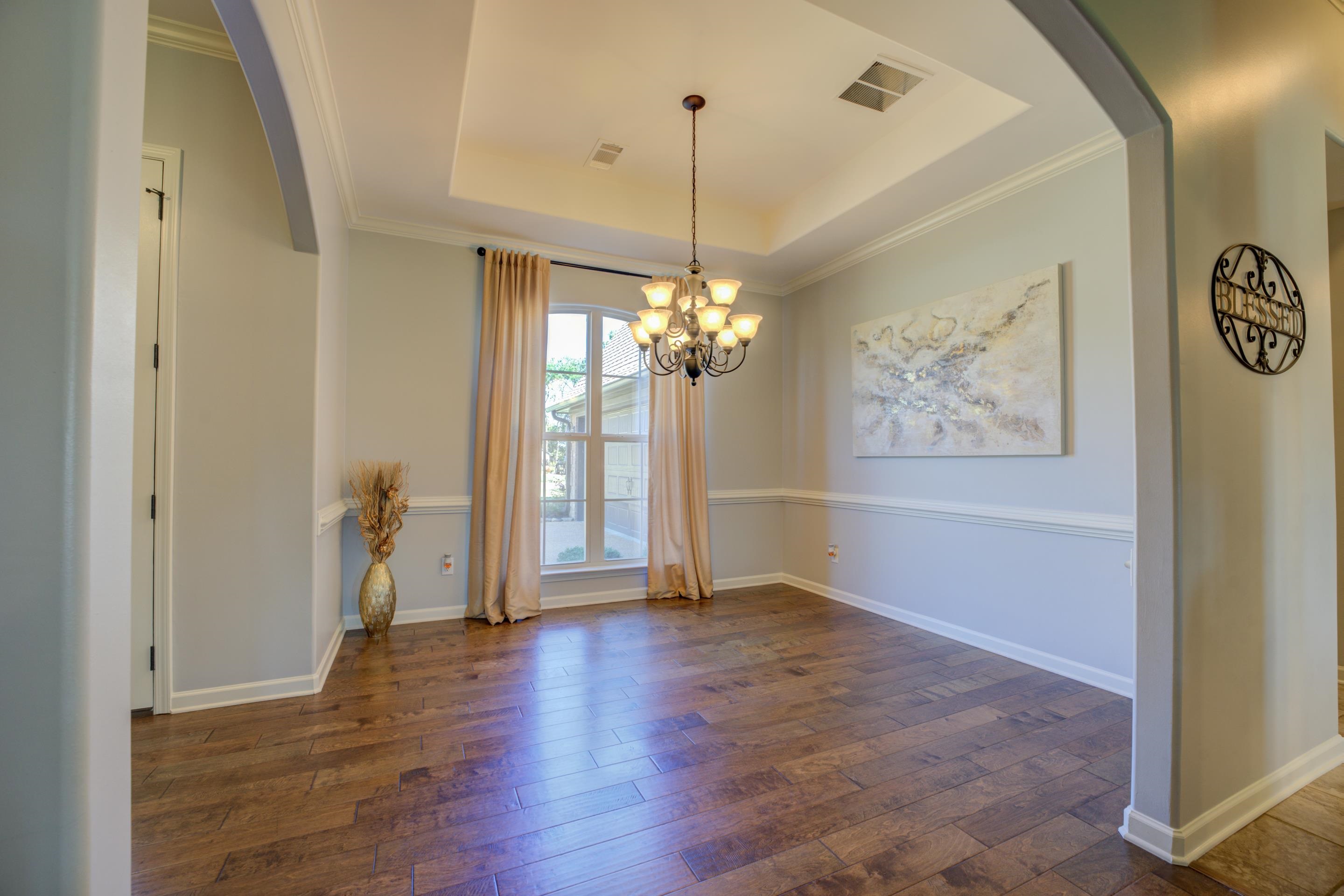 370 Pearl Road Somerville, TN 38068 - Photo 7 of 39 Unfurnished dining area with ornamental molding, a tray ceiling, and dark hardwood / wood-style flooring