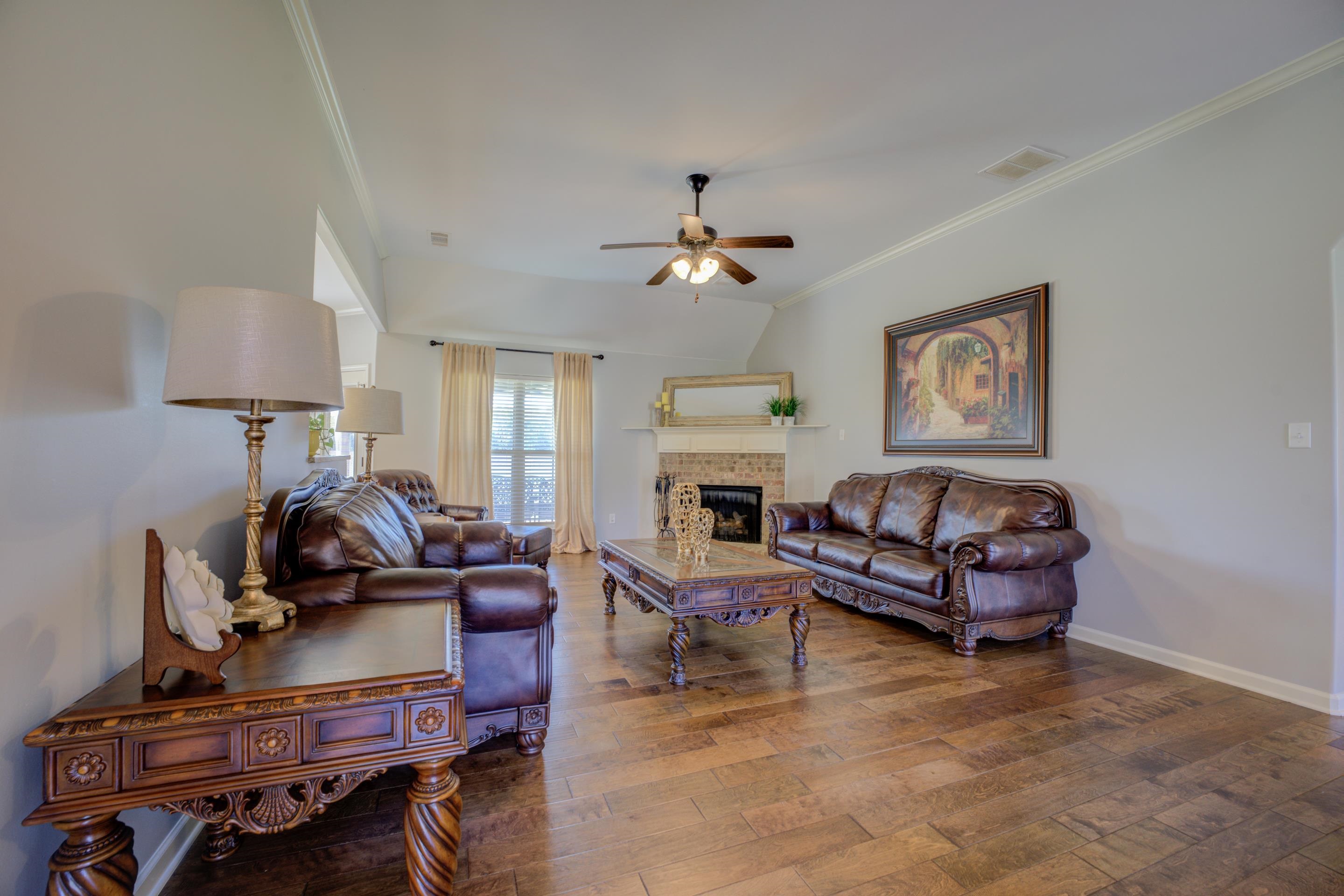 370 Pearl Road Somerville, TN 38068 - Photo 10 of 39 Living room with ornamental molding, a fireplace, ceiling fan, and hardwood / wood-style floors
