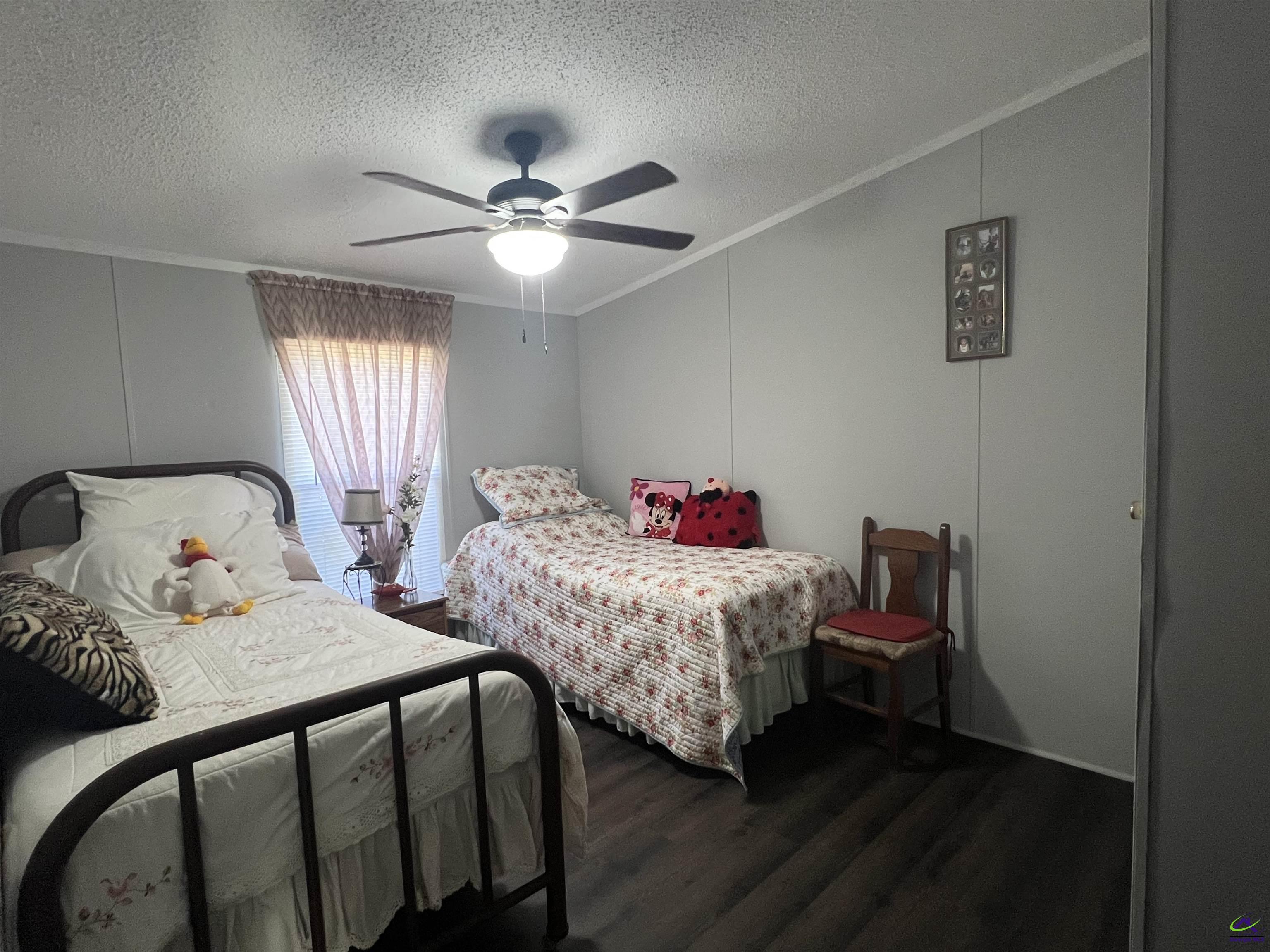 166 Pebble Hills Road Cochran, GA 31014 - Photo 27 of 27 a bedroom with two beds and a chandelier