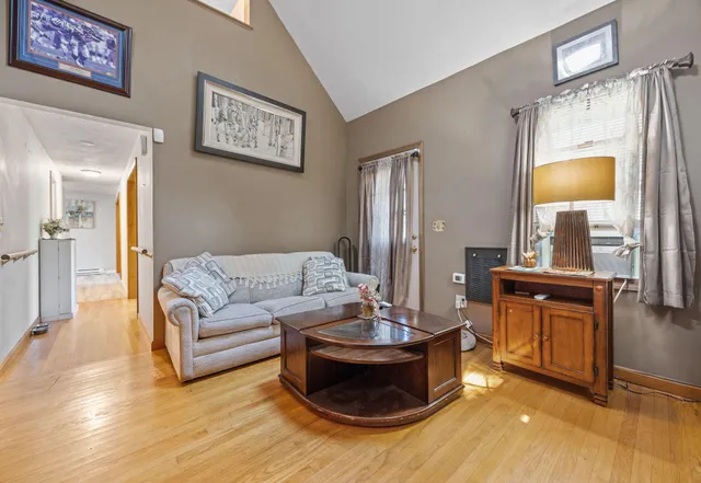 a living room with furniture and a mirror