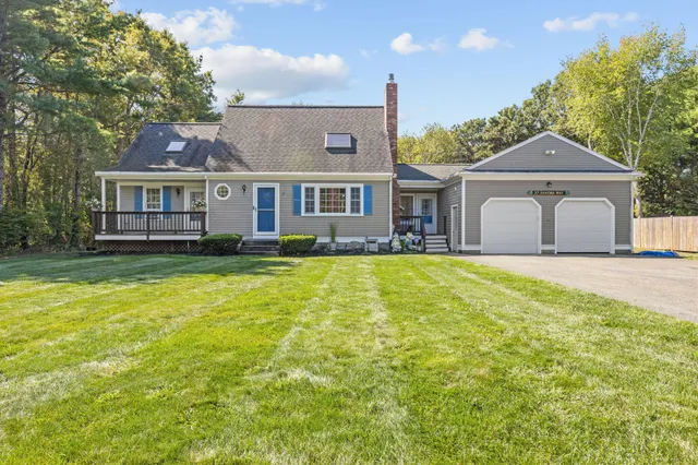 a front view of a house with a yard