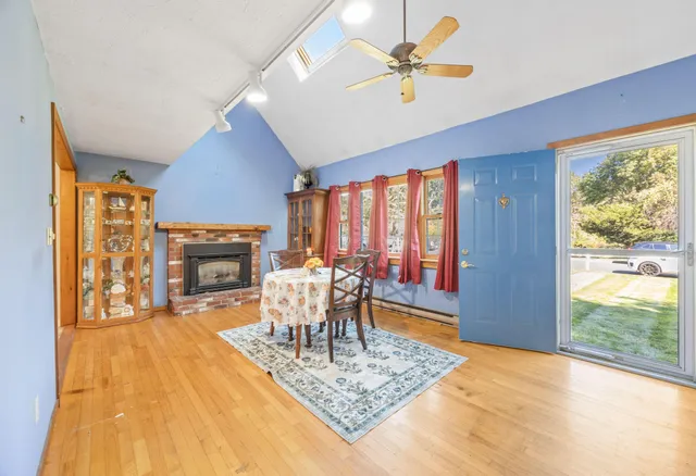 a dining room with a table chairs and a fireplace