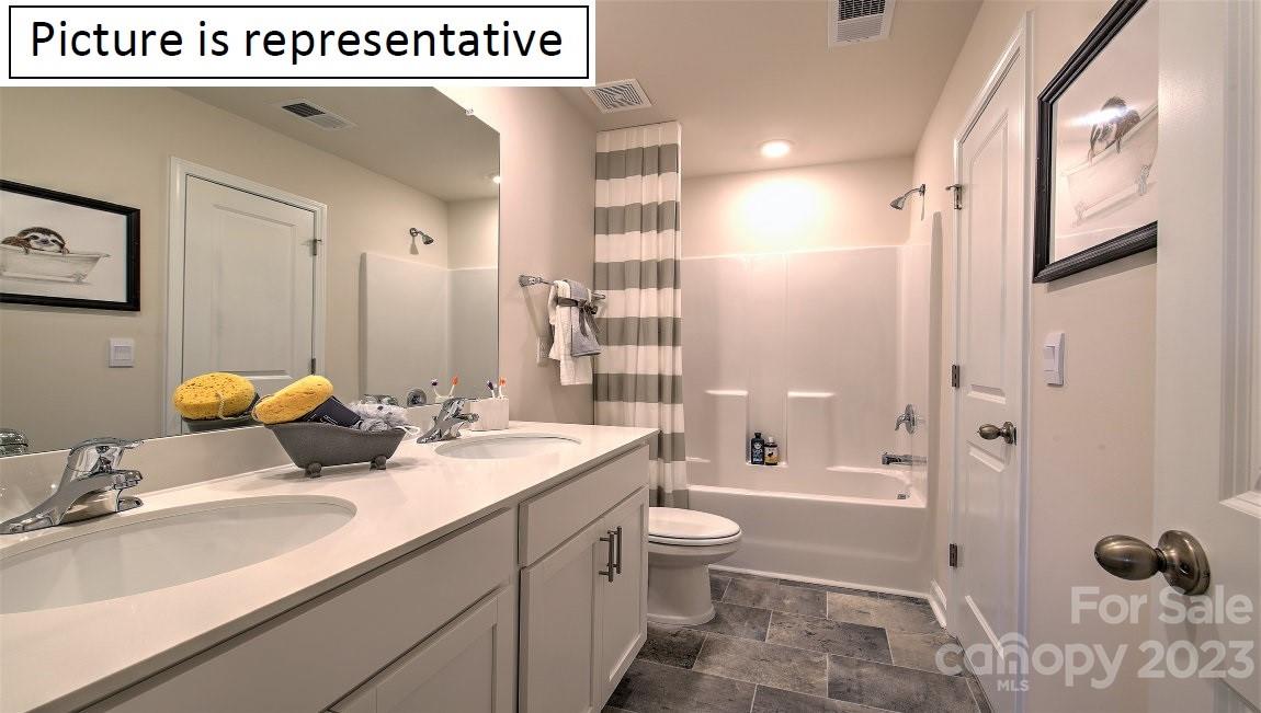 2016 Vanderlyn Street Monroe, NC 28112 - Photo 31 of 32 a bathroom with a granite countertop sink mirror vanity and toilet