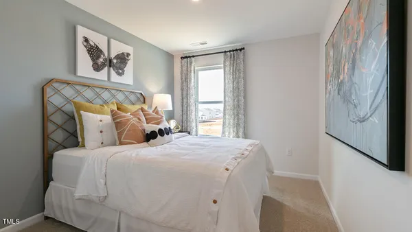 a bedroom with a large bed and a window